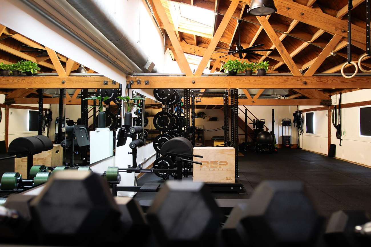 The private training floor, timber trusses and racks at Praxis