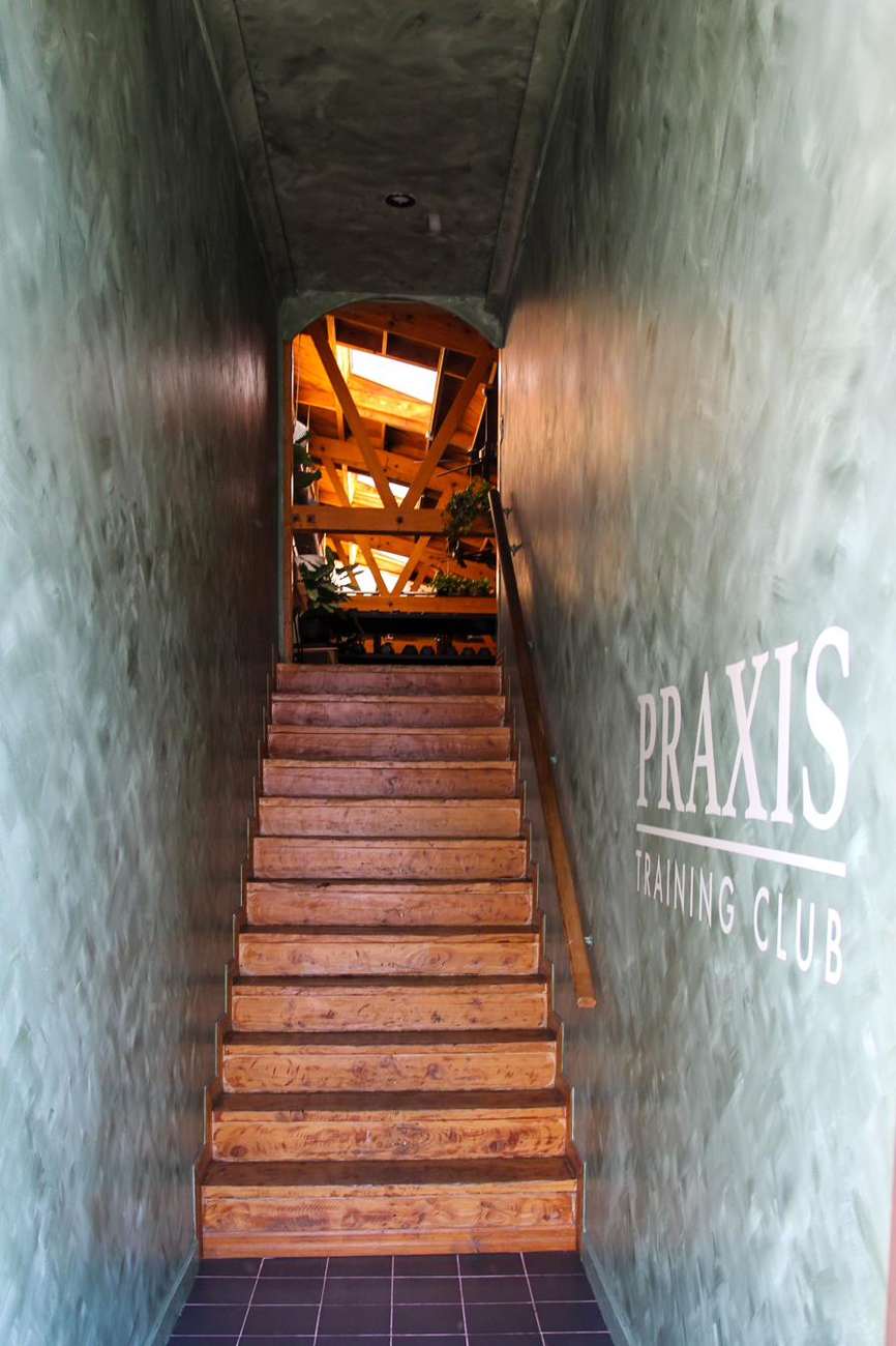 The stairwell up to the club, Praxis painted on the wall